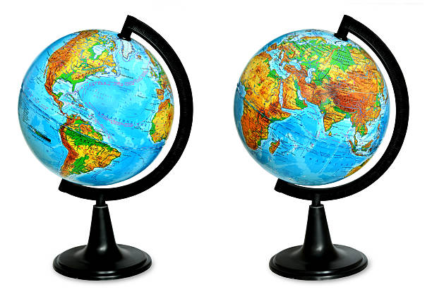 A pen on the desk and a small blue globe