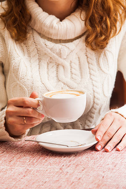 Woman's hands and cappuccino