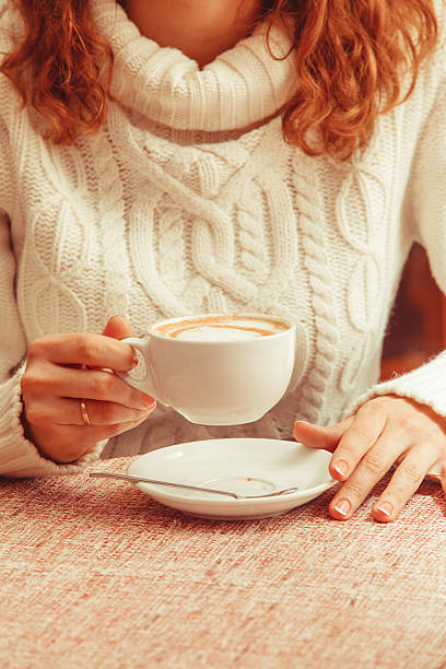 Woman's hands and cappuccino