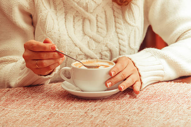 Woman's hands and cappuccino