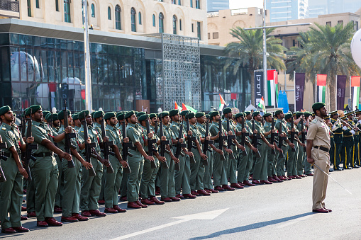 Dark-skinned soldier in hat facing national flag series - Jordan