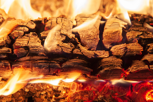 Burning piece of wood in a fireplace close-up
