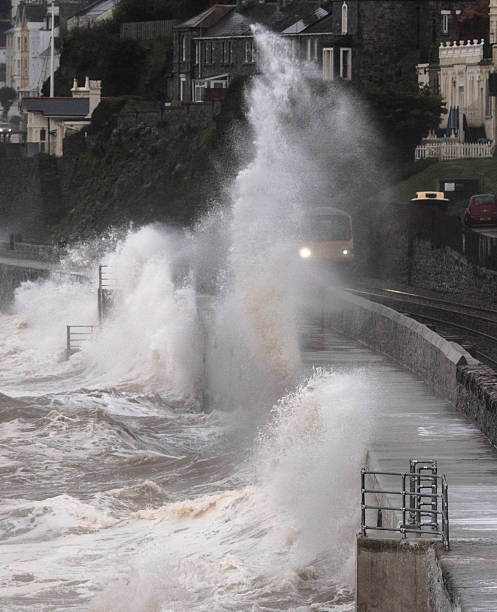 istock Local train drenched at Dawlish alongside the repaired sea wall 503336068