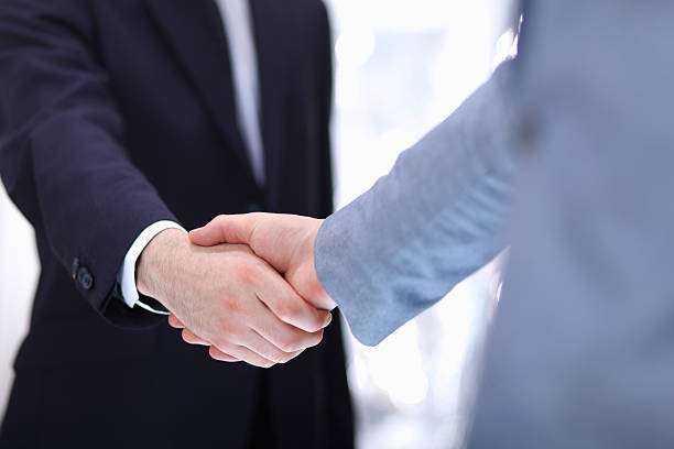 istock Businessmen shaking hands, isolated on white background 503337046