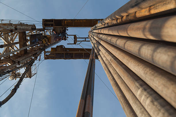 istock Oil rig while drilling with pipes on side at sunset 503337078