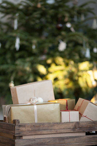 istock Wrapped gifts against Christmas tree background 503338462
