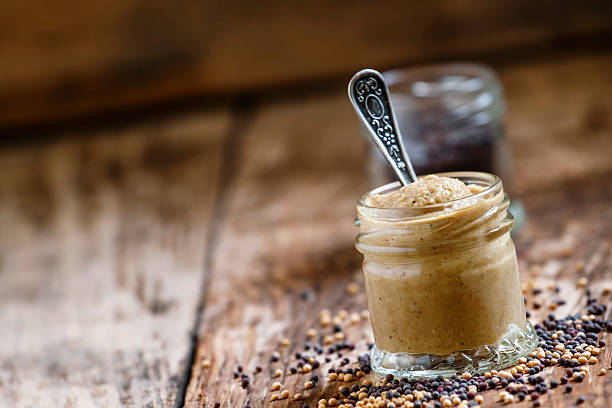 istock Mustard in a glass jar and seeds 503339202