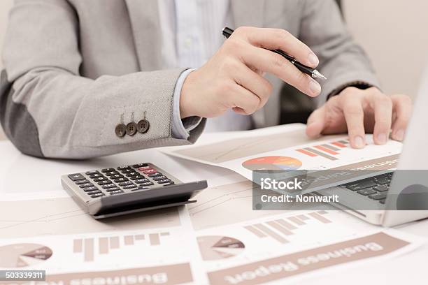Businessman Analyzing Investment Charts With Laptop Accounting Stock Photo - Download Image Now