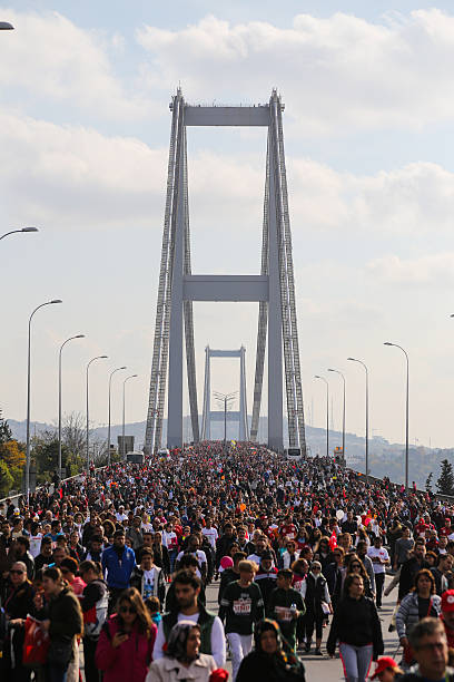 37th Vodafone Istanbul Marathon Istanbul, Turkey - November 15, 2015: People are crossing the Bosphorus Bridge from Asia to Europe during 37th Istanbul Marathon.  water athlete competitive sport vertical stock pictures, royalty-free photos & images