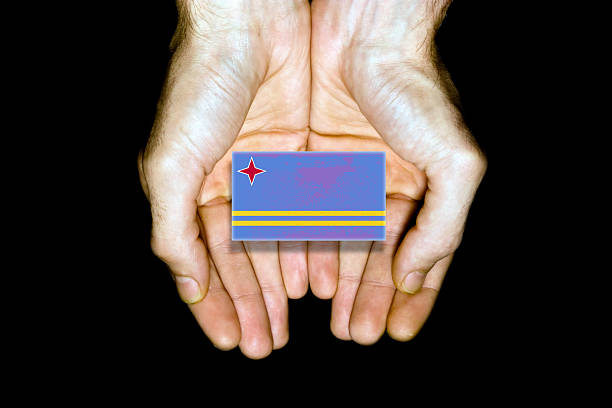 istock Flag of Aruba in hands on black background 503342021