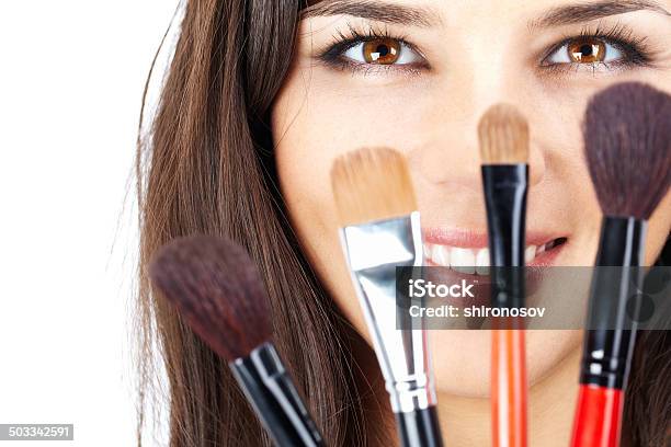 Face Behind Brushes Stock Photo - Download Image Now - Adult, Adults Only, Applying