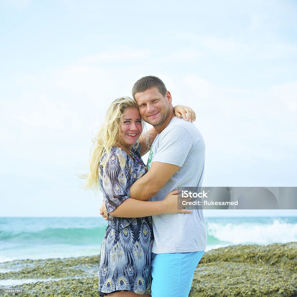 couple in love on the beach at summer day portrait of a happy couple in love on the beach at summer day Adult Stock Photo