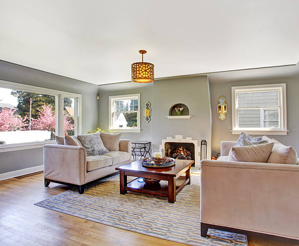 istock Light grey living room with white sofas and fireplace 503343459