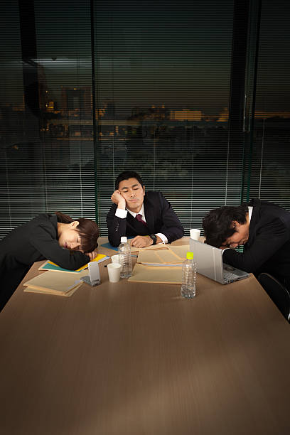 istock Exhausted Japanese Business Office Workers in Meeting Vertical 503343647