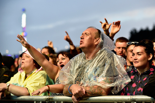 Dundrennan, Scotland - July 26, 2014: Members of the public at a music festival in south west Scotland just after an evening rain shower.