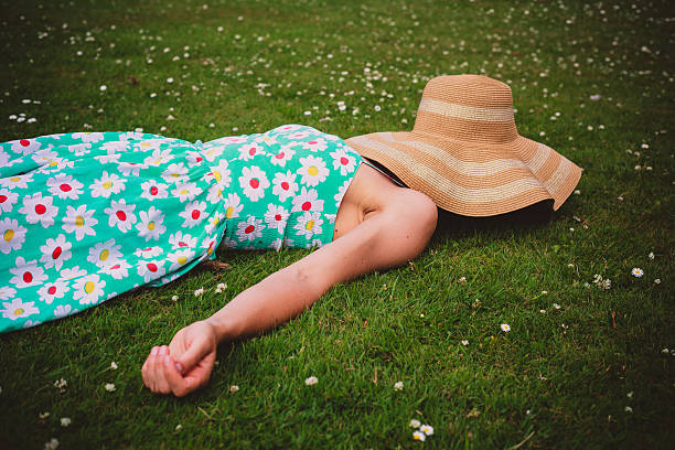 High school student exhausted from exams, taking a break on a couch with a book over their face, showing tiredness and the need for relaxation.