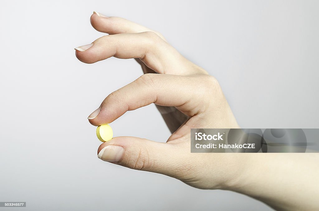 Pill in hand Adult Stock Photo