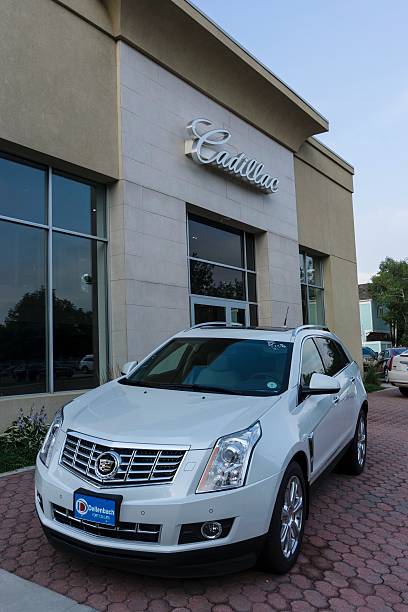 Cadillac Fort Collins, Colorado, USA - July 27, 2014: Street side view of cars parked in front of a Cadillac dealership in Fort Collins. goldco company review stock pictures, royalty-free photos & images