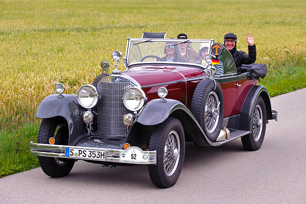Classic car rally with Mercedes Landsberg, Germany - July 12, 2014: A public oldtimer rally, named Herkomer-Konkurrenz, is organized for at least 80 years old classic cars in Bavarian city Landsberg. Approx. 75 veteran cars participate at this event with their unidentified drivers and passengers. The route runs on public streets through the rural landscape and small villages of Bavaria. Here you see an Mercedes, built at year 1926 1926 stock pictures, royalty-free photos & images