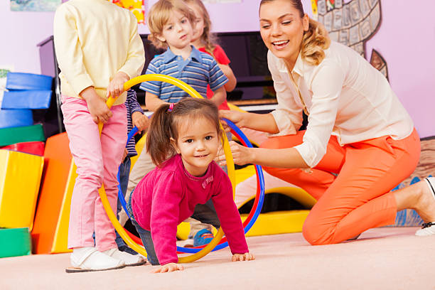 istock Kids with girl and teacher play active game 503353628