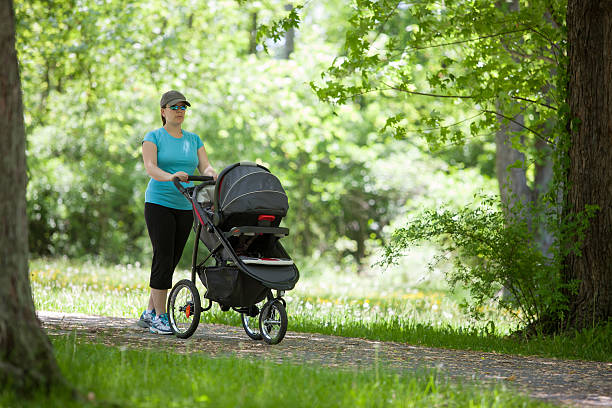 istock Young woman with a stroller 503354198