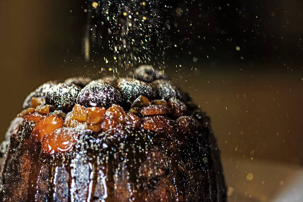 Christmas Pudding with Golden Glitter Sugar 1 Christmas is known for gorgeous Christmas puddings and cake. Glazed fruit crowning the beautiful favours.  christmas pudding stock pictures, royalty-free photos & images