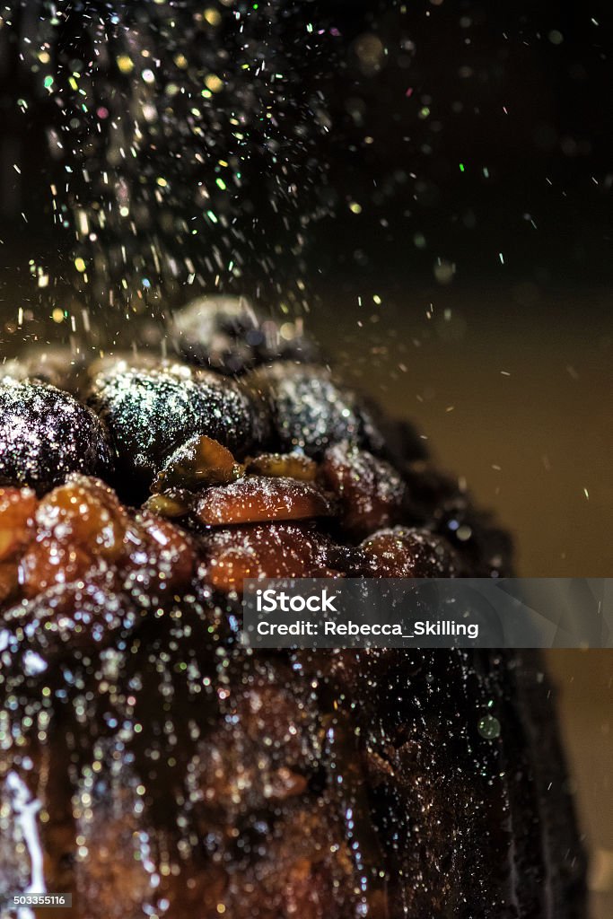 Christmas Pudding with Golden Glitter Sugar 4 Christmas is known for gorgeous Christmas puddings and cake. Glazed fruit crowning the beautiful favours.  Christmas Pudding Stock Photo