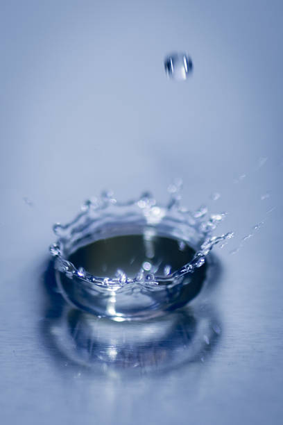 istock Close up abstract water drops splash on blue background 503358862