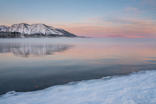 The sky starts to change color on the northern horizon at Lake Tahoe during the winter