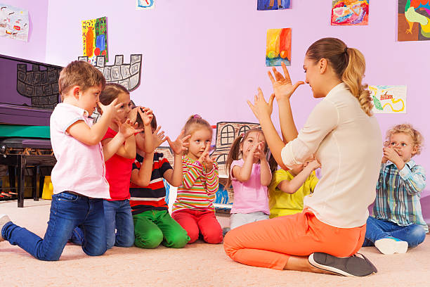 istock Kids repeat gesture in classroom after teacher 503362230