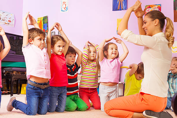 istock Group of kids repeat gesture after the teacher 503362524