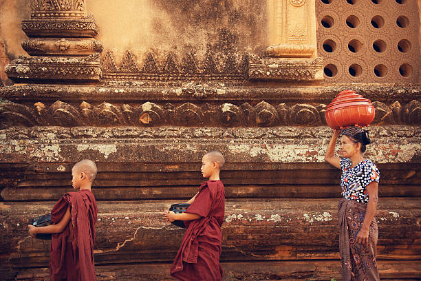 istock Buddhist novice monks collect alms 503362876