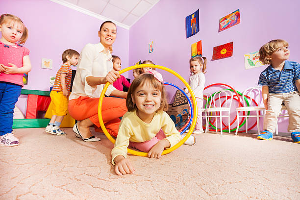 istock Little girl and other kids crawl though hoops 503365614