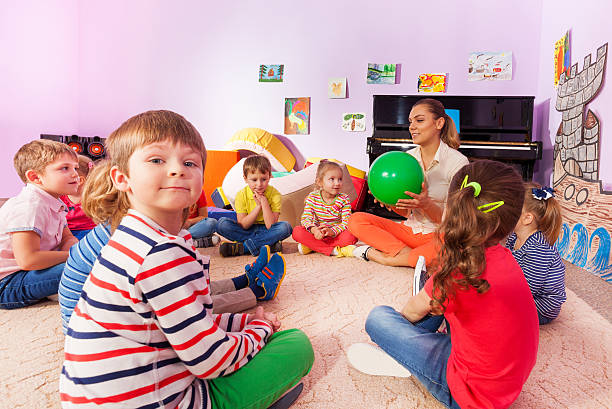 Kids and teacher sit in circle