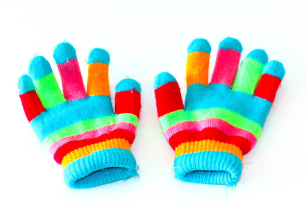 Funny girl in colored curly wig shows hand in multicolor glove