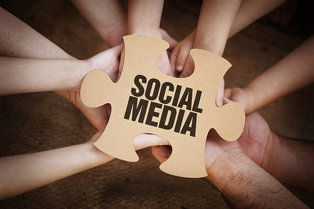 istock Social Media on Cardboard Jigsaw Puzzle Piece in Hands 503371447
