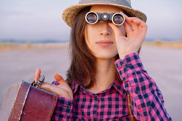 istock Woman looks through binoculars 503371723
