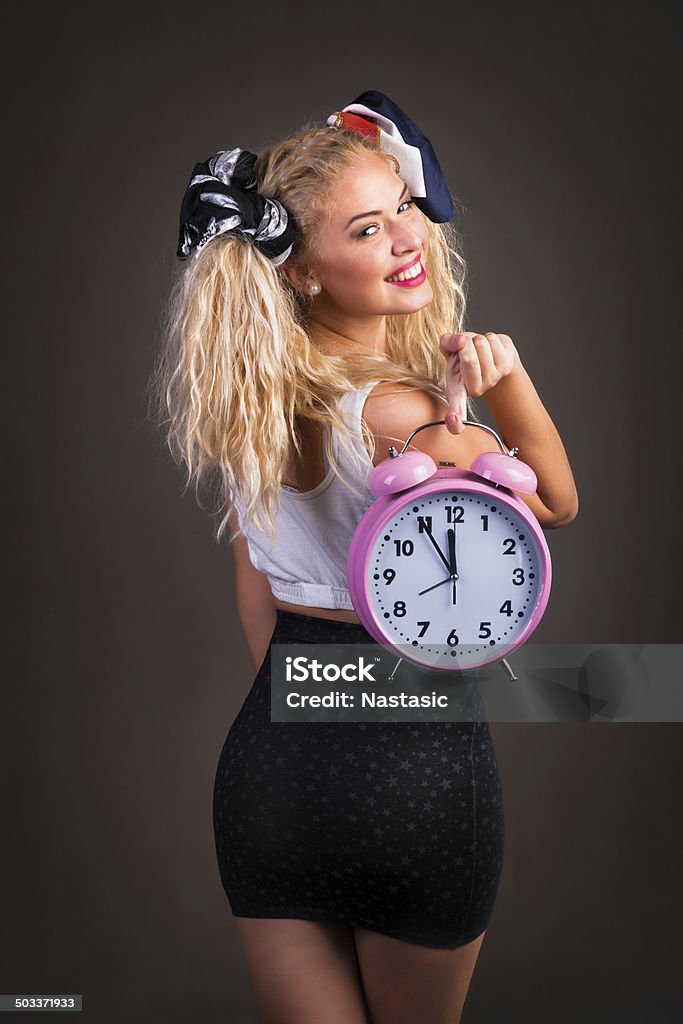 young woman posing Beautiful young woman posing holding clock isolated on black 20-24 Years Stock Photo