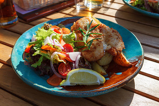 istock Main course - fish with baked potatoes and vegetables 503372399