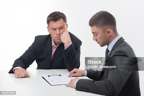 Two Business People In Elegant Suits Chief And Employee Holdin Stock Photo - Download Image Now