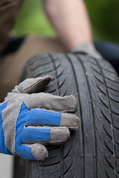 istock Mechanic hands and car tire 503376245