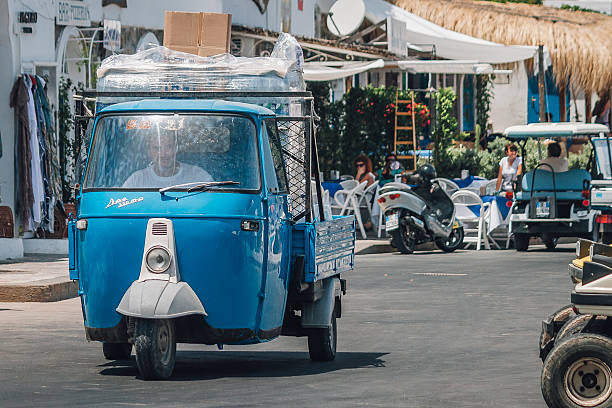 Salesman delivers his goods on the island of Panarea, Italy Panarea (Sicily), Italy - 10 July 2012: A salesman on Panarea transports his goods using the typical three-wheeled van (Ape) of Sicily and the Aeolian Islands. panarea island stock pictures, royalty-free photos & images