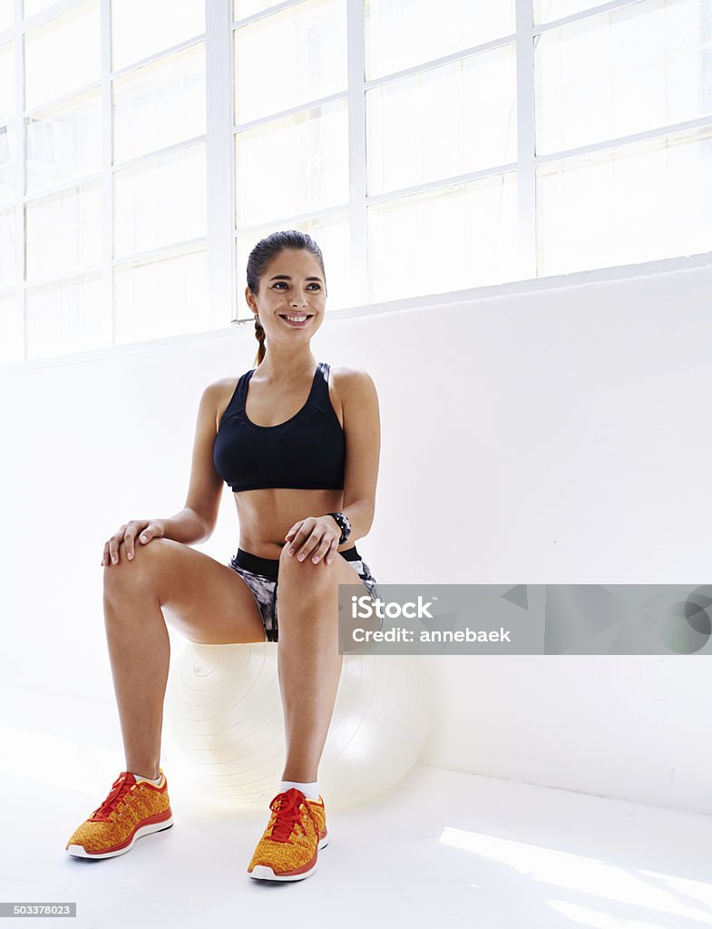 Having a ball with this workout Shot of an attractive young woman sitting on a fitness ball 30-39 Years Stock Photo