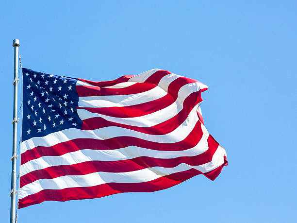 istock USA Flag on blue sky 503386358