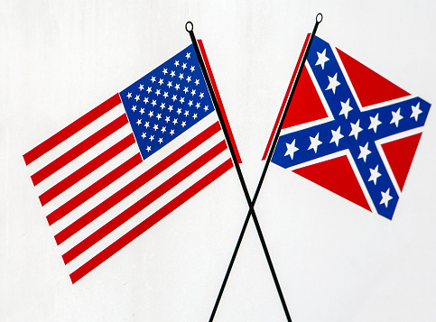 A USA flag next to a confederate flag