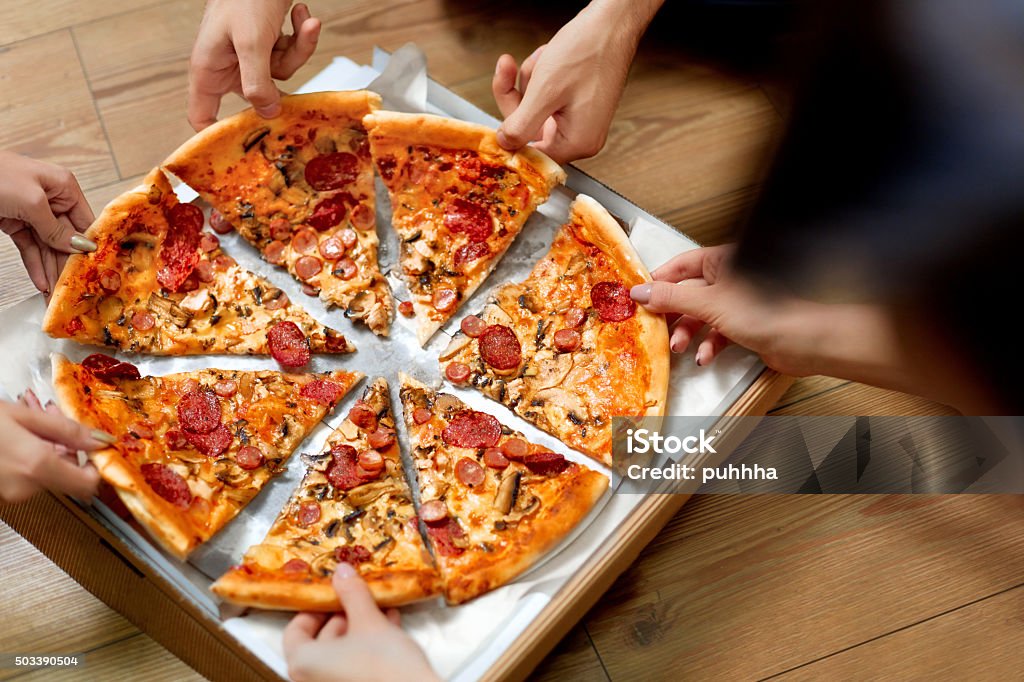 Eating Pizza. Group Of Friends Sharing Pizza. Fast Food, Leisure Eating Pizza. Group Of Friends Sharing Pizza Together. People Hands Taking Slices Of Pepperoni Pizza.  Fast Food, Friendship, Leisure, Lifestyle. Party - Social Event Stock Photo
