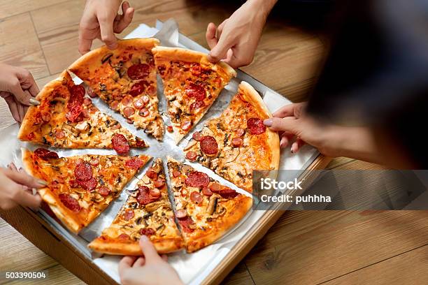 Eating Pizza Group Of Friends Sharing Pizza Fast Food Leisure Stock Photo - Download Image Now