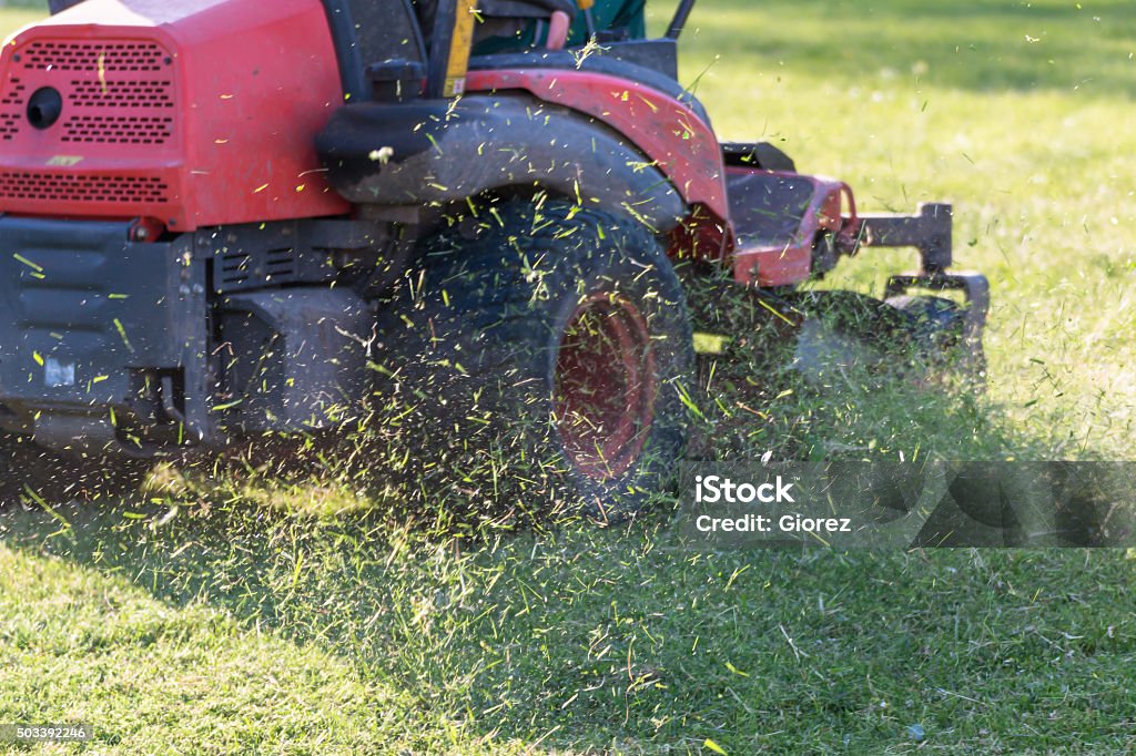 Riding Lawn Equipment with operator Riding Lawn Equipment with operator for periodically garden upkeep Lawn Mower Stock Photo