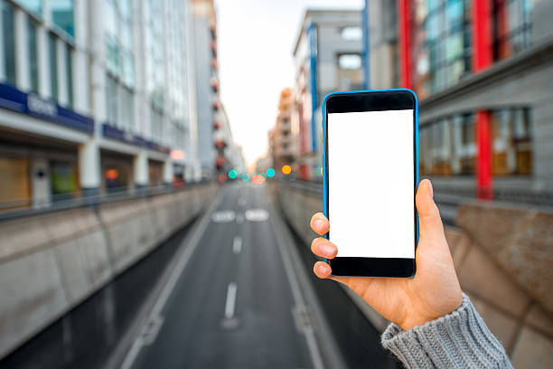 istock Holding Smartphone on the city background 503392414