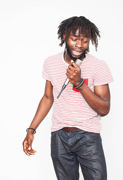 istock young handsome african american boy singing emotional with microphone isolated 503394646